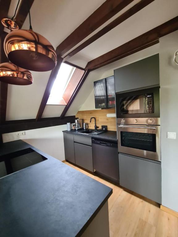 a kitchen with a counter top and a stove at Ferienhaus Chiemgauer Auszeit- Chiemgaukarte inclusive in Siegsdorf