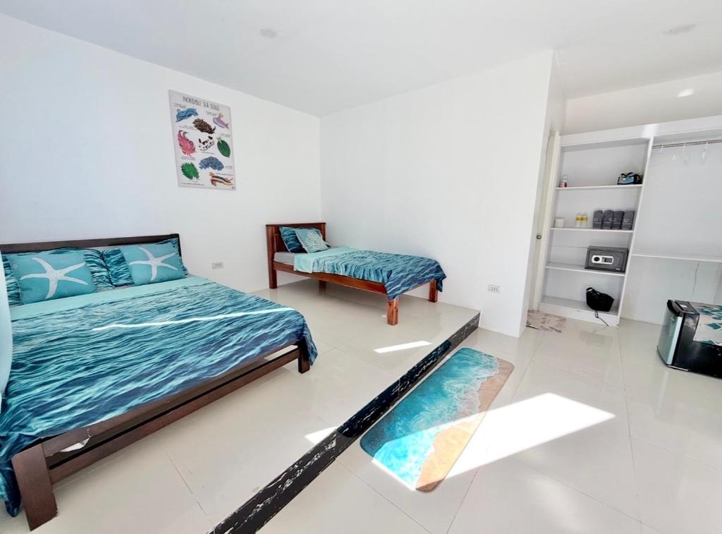 a bedroom with a bed and a chair at Under the sea diving resort in Lapu Lapu City