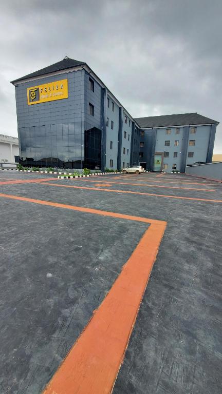 a large building with a yellow sign on it at Feliza Hotel and Suites in Abeokuta