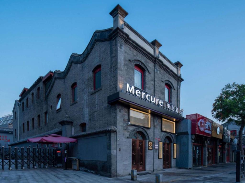 a brick building with a sign on the side of it at Mercure Beijing Tiananmen Square Qianmen Street in Beijing