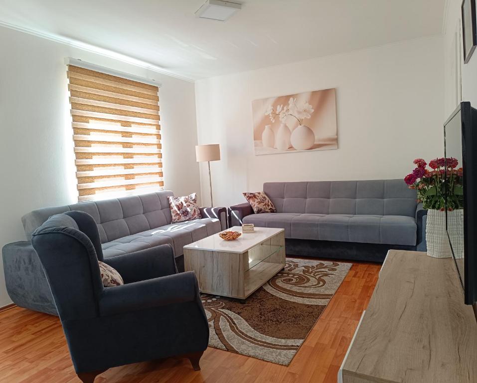 a living room with a couch and a table at Apartman Orhideja in Višegrad