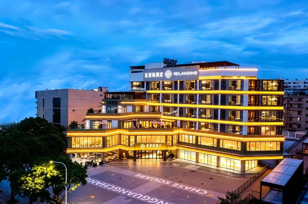 a building with a lit up facade at night at 珠海复登临酒店 Relanding Hotel in Zhuhai