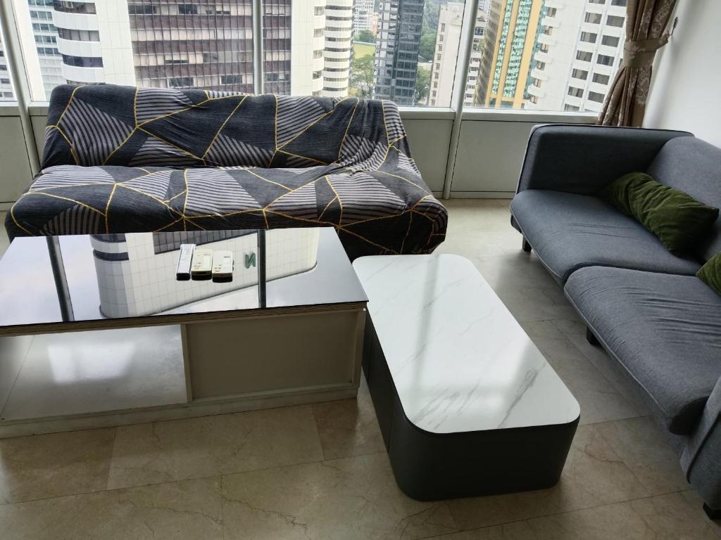 a living room with a couch and a coffee table at Sky Apart-Hotel klcc in Kuala Lumpur