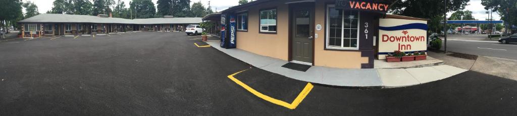 a parking lot with a building on the side of a street at Downtown Inn in Eugene