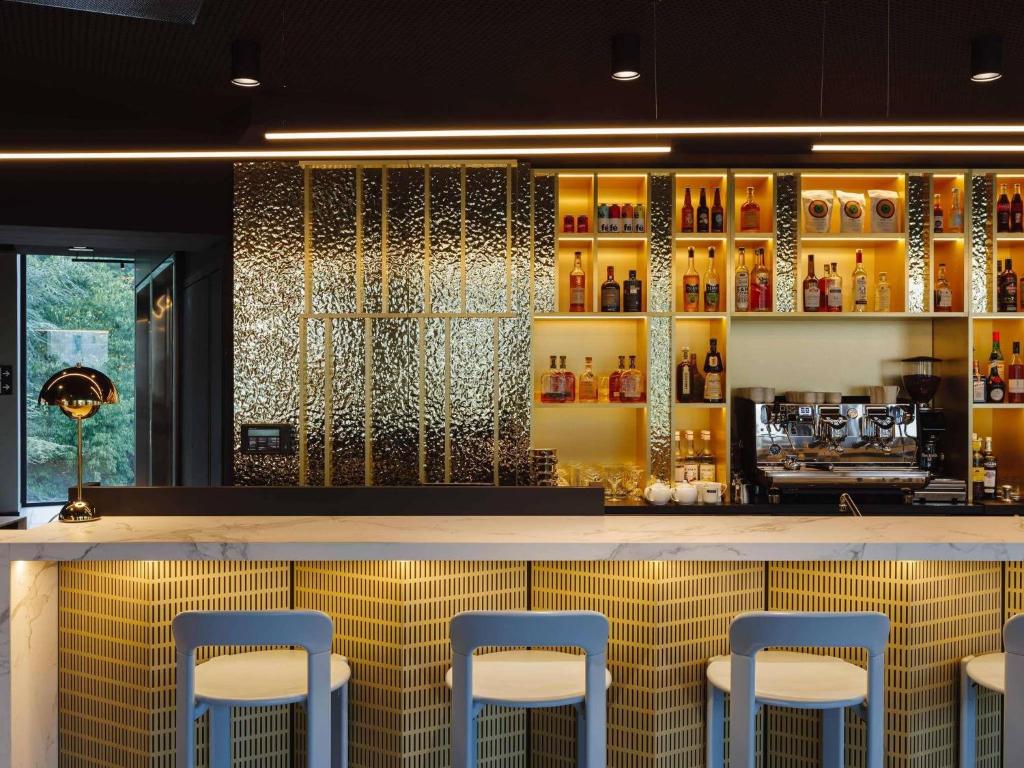a bar with blue stools in a restaurant at TRIBE Lyon Croix Rousse in Lyon