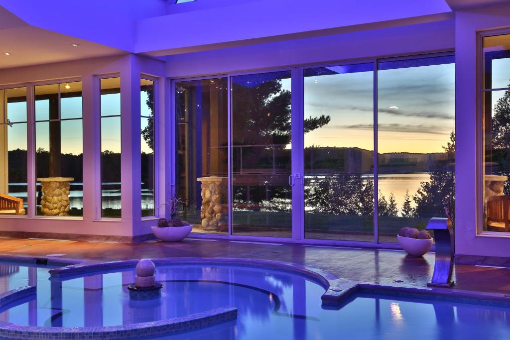 a swimming pool in a house with a view of the water at Sir Sam's Inn & Spa in Haliburton