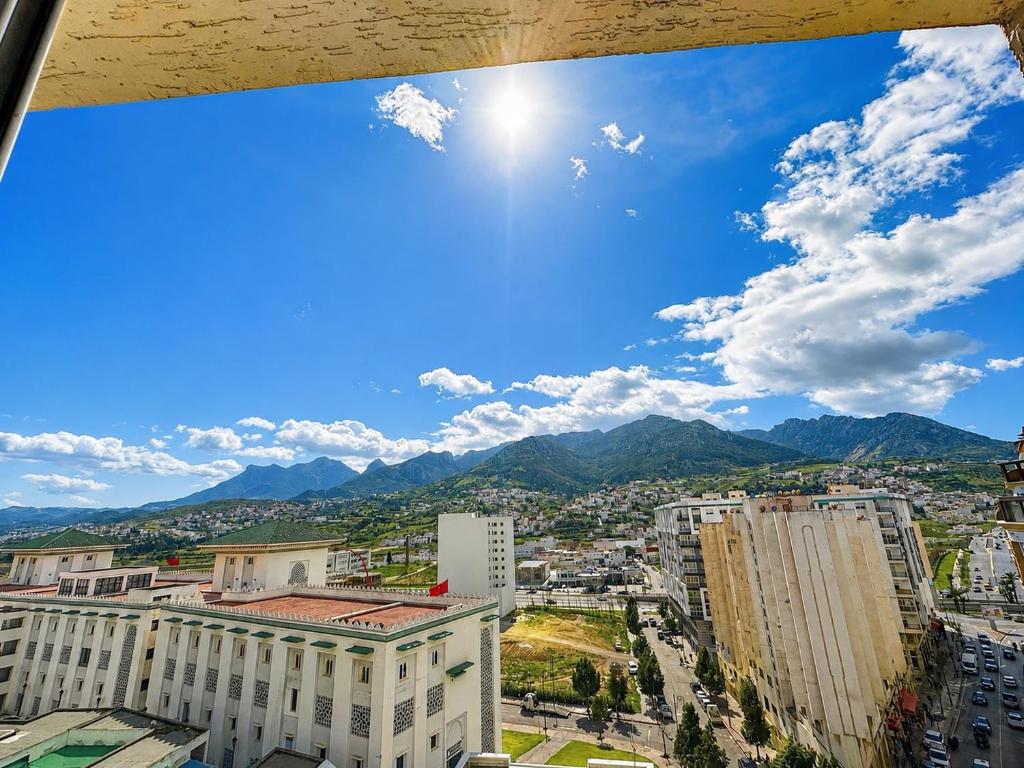 a view of a city with mountains in the background at Tetouan house vue- chambre climatisée in Tétouan