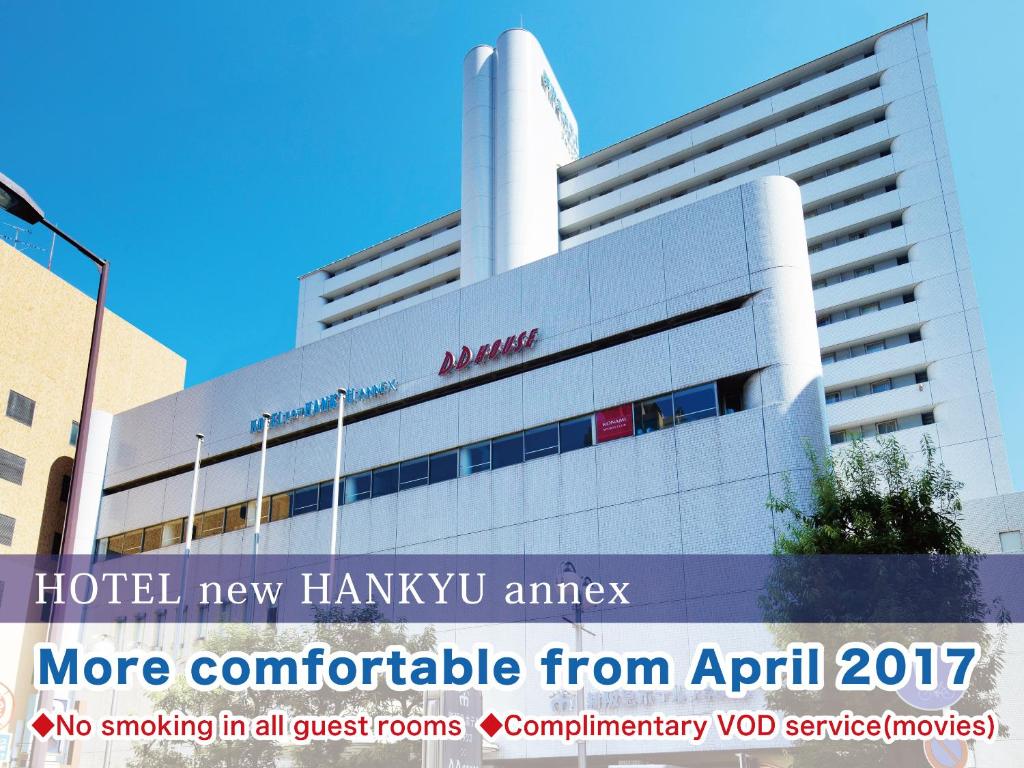 a hotel new haminy iv amr building with a sign at Hotel New Hankyu Osaka Annex in Osaka