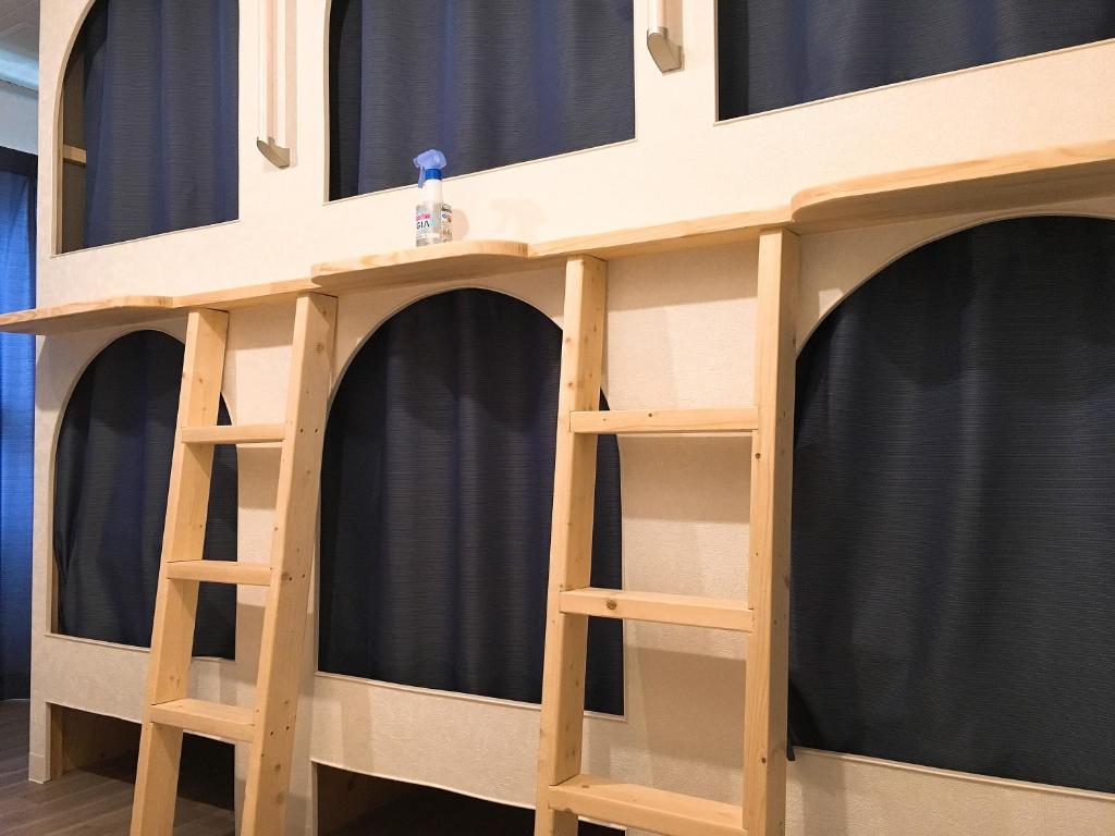 a wooden play house with four shelves at Hiroshima Guesthouse HARU in Hiroshima
