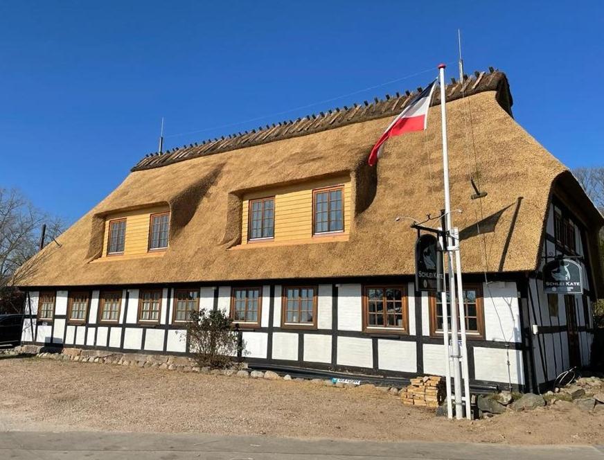 a large building with a flag in front of it at Zur Schleikate in Boren