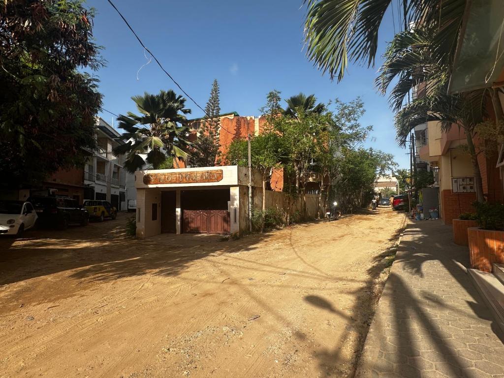 a dirt road with a building on the side of a street at Villa malaka in Dakar