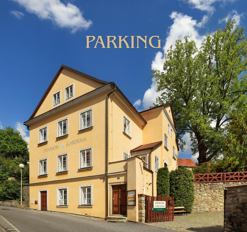 a large yellow building on the side of a street at Penzion Gardena in Český Krumlov