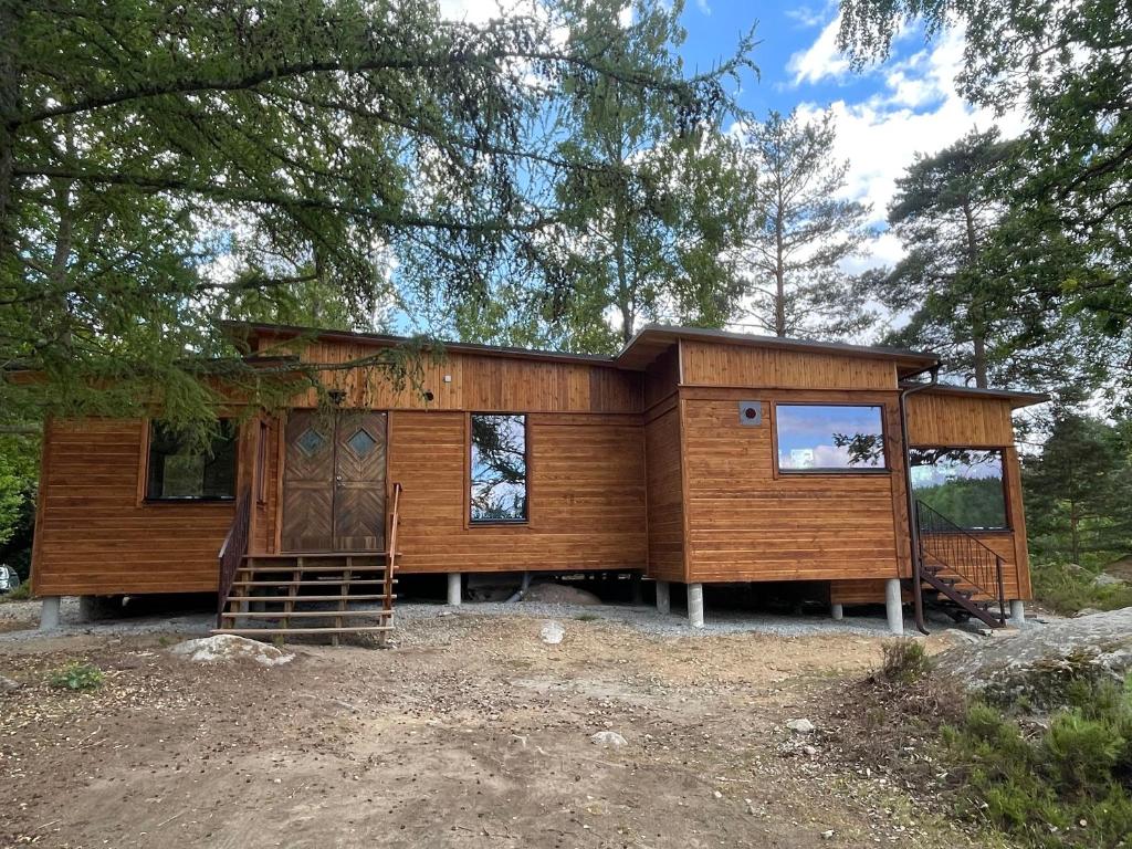 a log cabin in the middle of a forest at Långasjönäs Camping & Stugby in Karlshamn