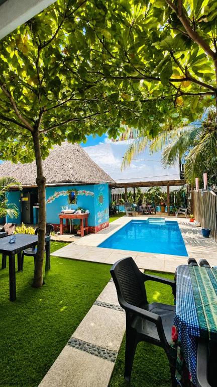 a resort with a pool and a table and chairs at Bedrooms where Charlie in El Paredón Buena Vista