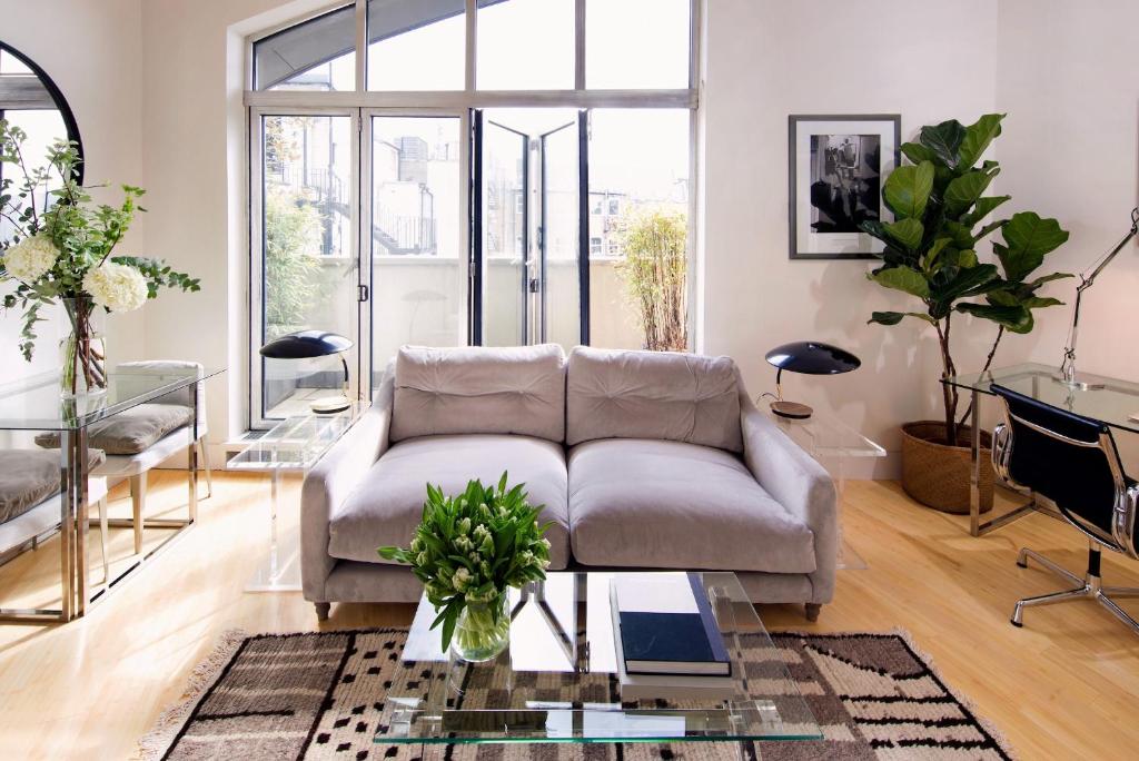 a living room with a couch and a glass table at No.5 Maddox Street in London