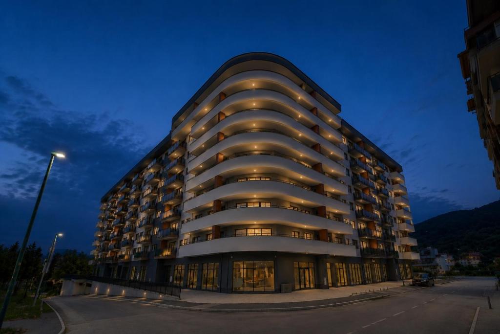 a building with lights on the side of it at NOVA Olimpia Residence - Free Garage in Sarajevo
