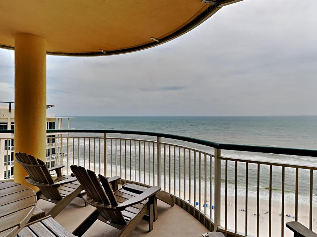 a balcony with chairs and a view of the ocean at Beach Colony East #15A in Perdido Key