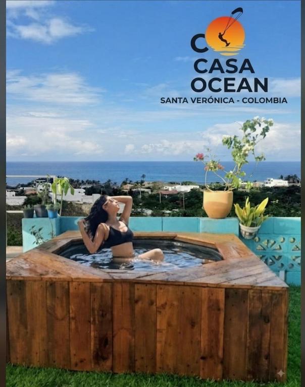 a woman sitting in a hot tub in the grass at CO Casa Ocean in Juan de Acosta