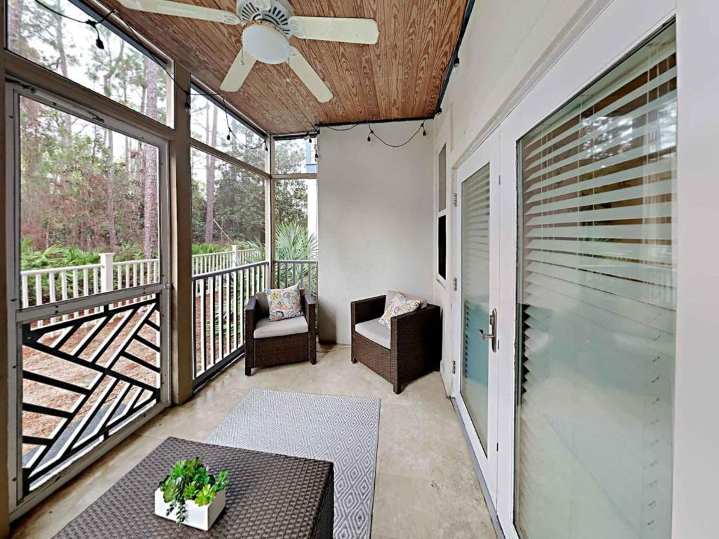 a balcony with a table and a ceiling fan at Seagrove Highlands #2104 in Santa Rosa Beach