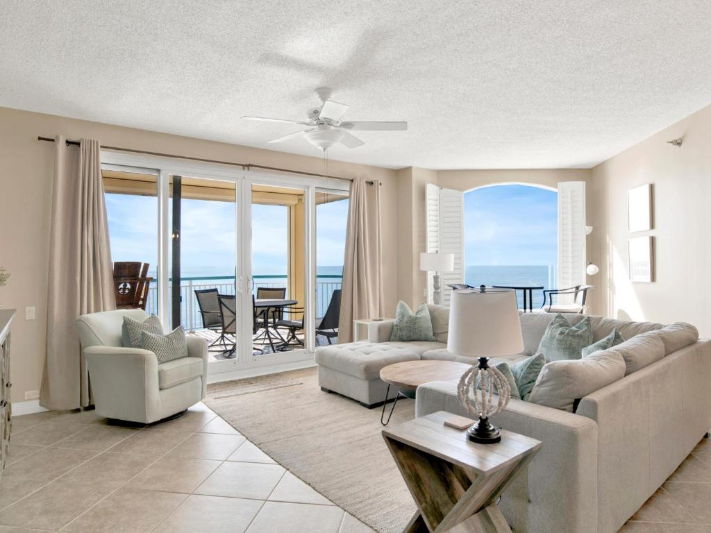 a living room with a couch and a table at Beach Colony Towers #15C in Perdido Key