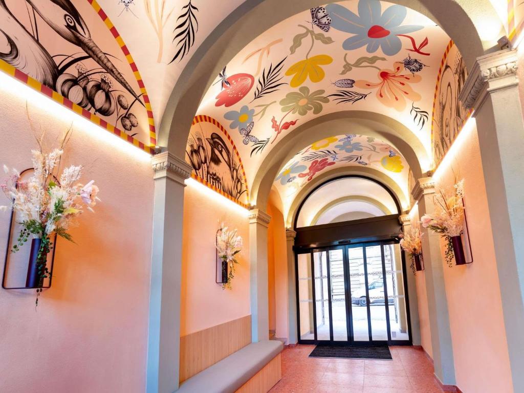 a hallway with flowers painted on the ceilings at Ibis Styles Strasbourg Centre République in Strasbourg