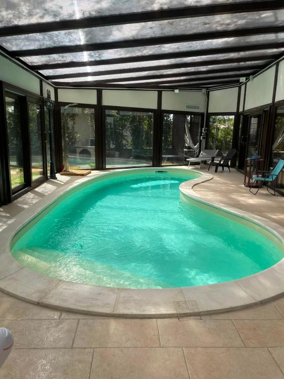 a swimming pool in a house with an open ceiling at B&B Etna Country in Tremestieri Etneo