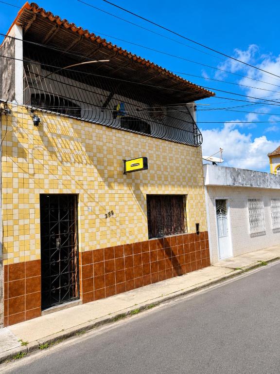 a yellow brick building on the side of a street at durmaaquislz2 in São Luís