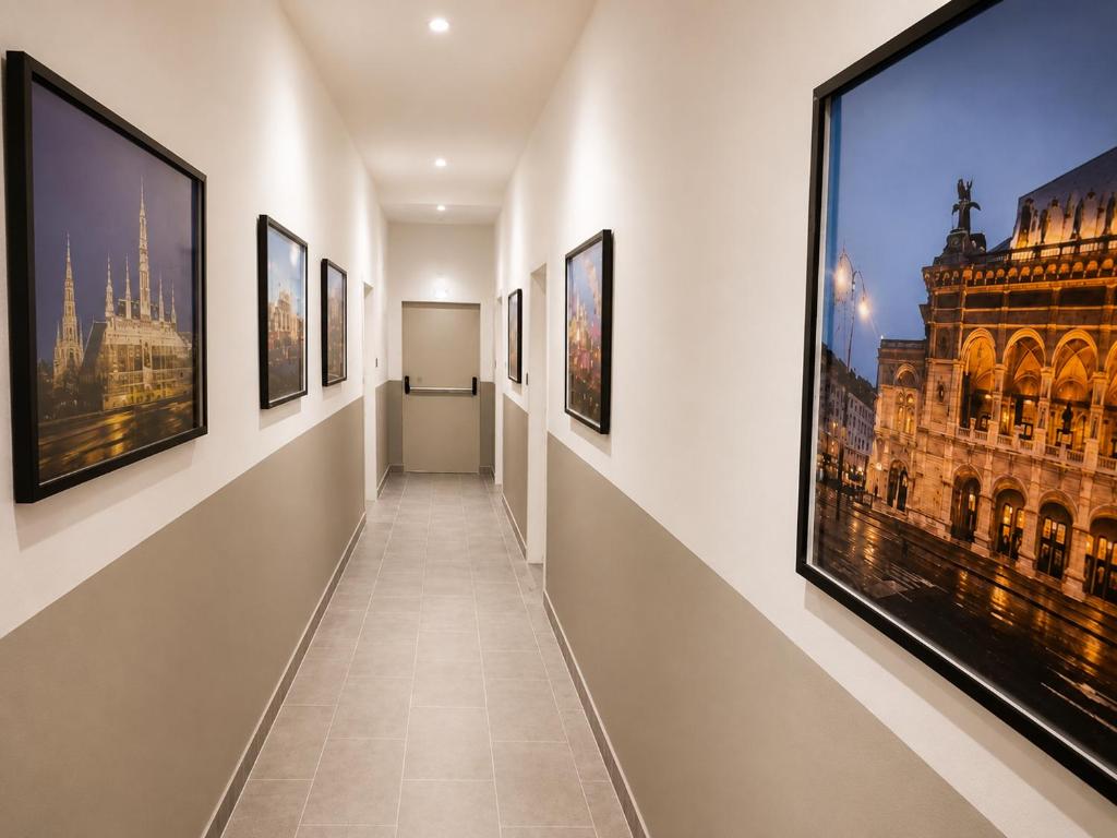 a corridor in a museum with paintings on the walls at Lenkev Living Aparts, Free Parking! in Vienna