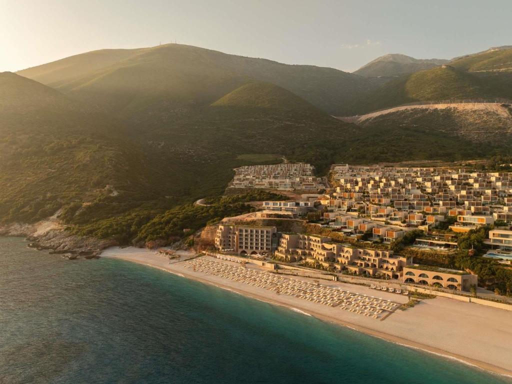 an aerial view of a resort on the beach at Green Coast Hotel MGallery Collection in Vlorë