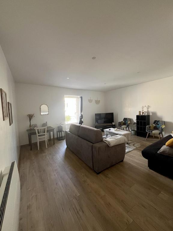 a living room with a couch and a table at Saint Blaise in Les Herbiers