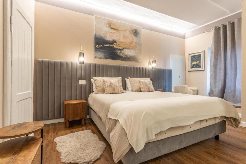 a bedroom with a large bed and a table at valter rooms 1 in Castel del Piano