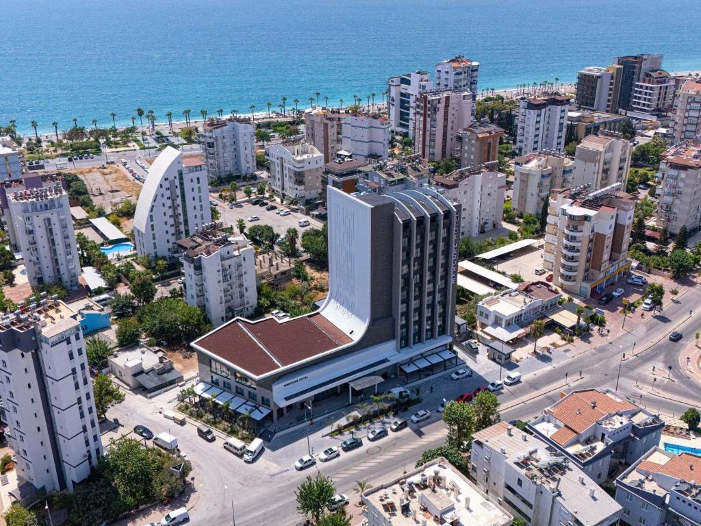 an aerial view of a city with the ocean at Mercure Antalya Konyaalti in Antalya