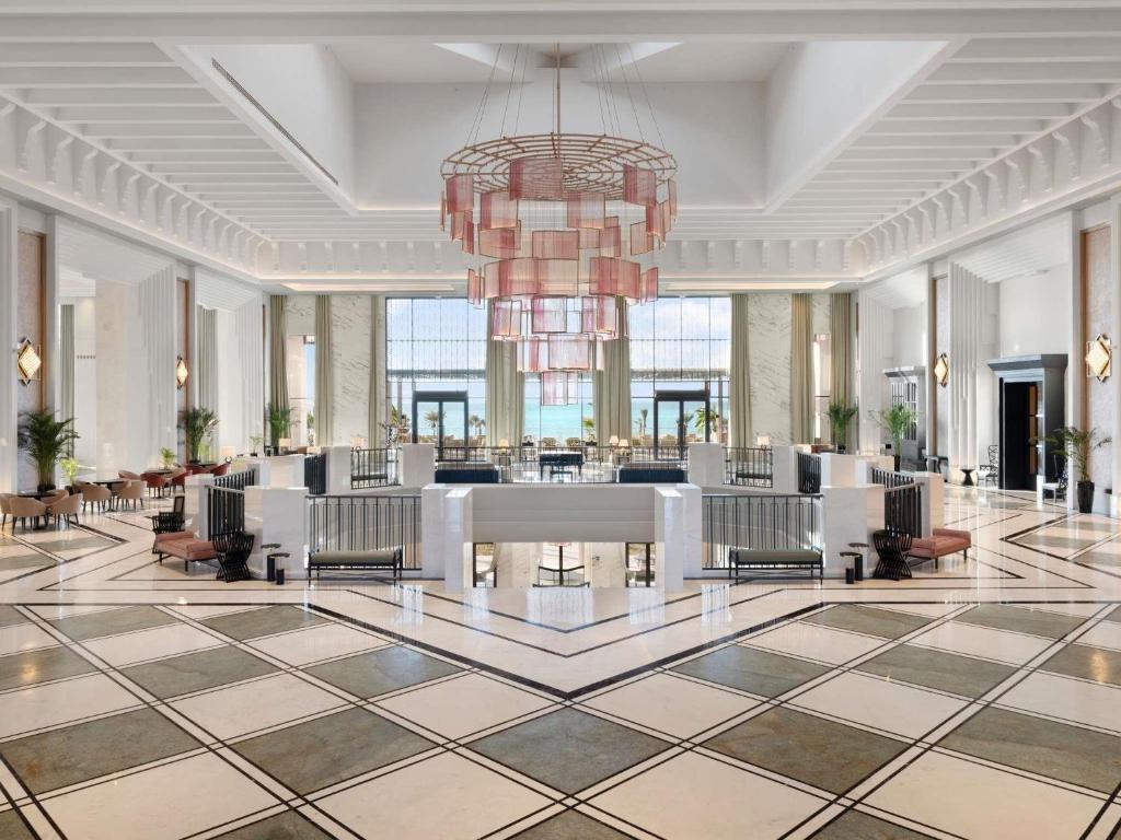 a lobby of a hotel with a chandelier at Rixos Murjana - Ultra All Inclusive in King Abdullah Economic City