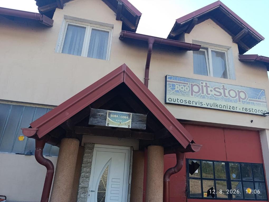 a building with a sign on the front of it at Pit - Stop 