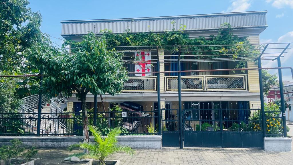 a building with a gate and trees in front of it at Welcome to Kobuleti in Kobuleti