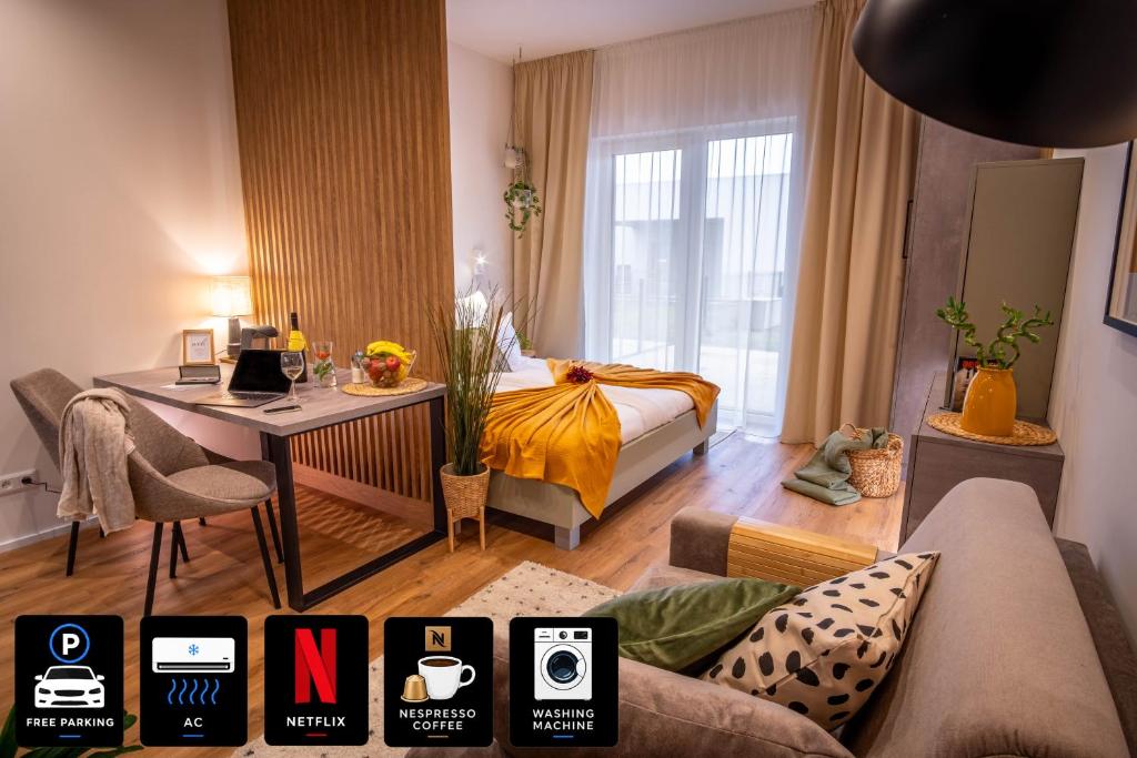 a living room with a bed and a desk in it at Between Rivers Apartments, AC, Netflix & Parking in Komárov