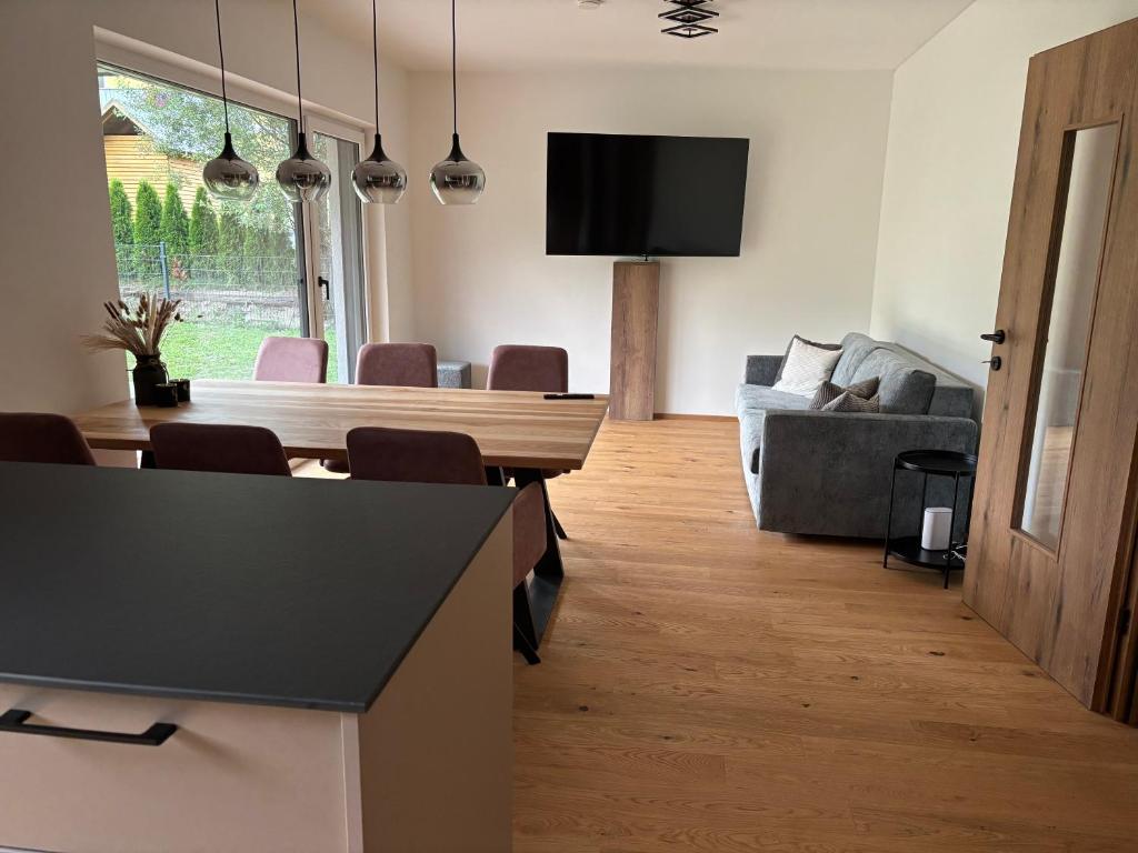 a living room with a table and a couch at Alpenoase Ennstal in Ennsling