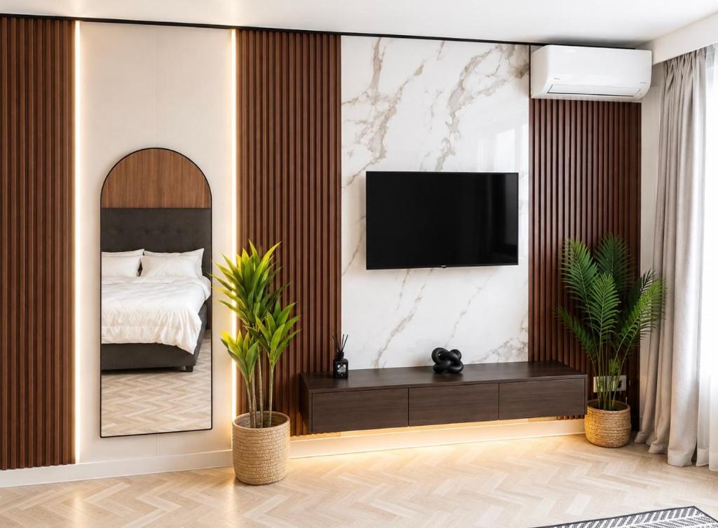 a bedroom with a bed and a tv on a wall at City Centre Oasis in Cape Town
