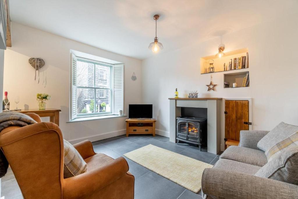 a living room with a couch and a fireplace at 1 Bed in Ambleside oc-lr036 in Ambleside