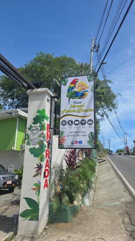 a sign for a restaurant on the side of the road at Hotel Manuel Antonio Beracha in Quepos