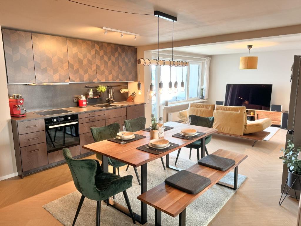 a kitchen and living room with a table and chairs at JUPAS - Premium Apartments Trier in Trier