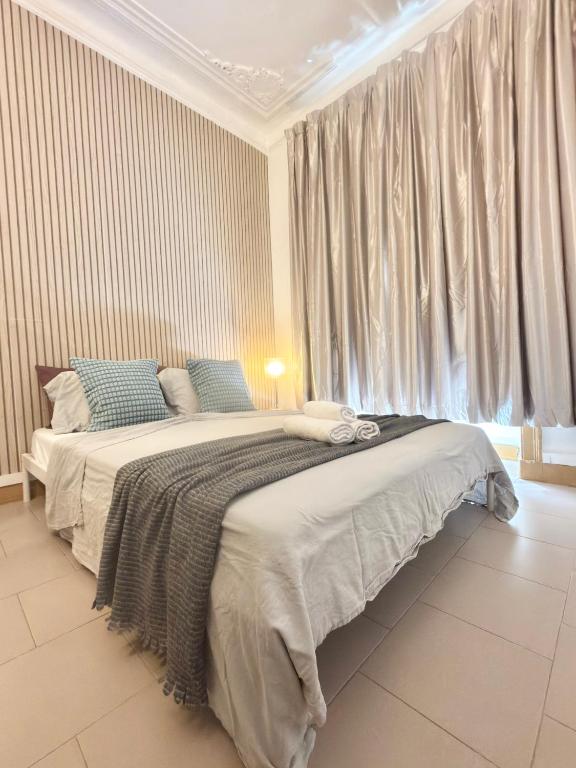 a bedroom with a large bed in front of a window at Frank's House & Happy BELEM in Lisbon
