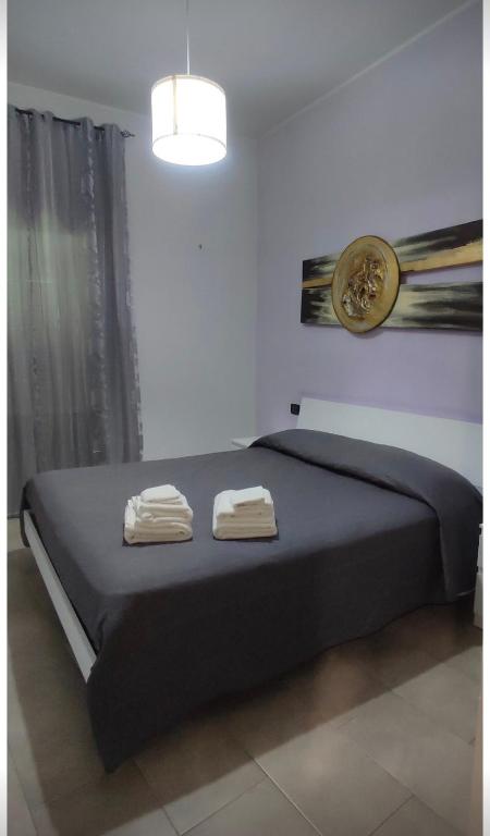a bedroom with a bed with two towels on it at Alloggio turistico Brancaleone in Genazzano
