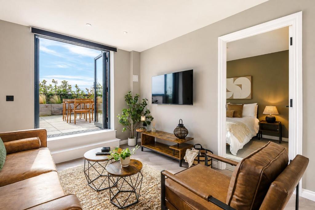 a living room with a couch and a bed at City Penthouse - Roof Terrace & Free Parking in Beeston Hill