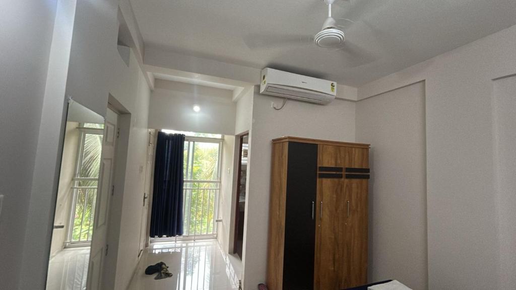 a room with a air conditioner on the ceiling at Stay near to temple 240m in Guruvāyūr