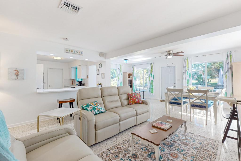 a living room with a couch and a table at 4 Mi to Beach! Lake-View Florida Family Retreat in JFK Medical Center Incorporated Heliport