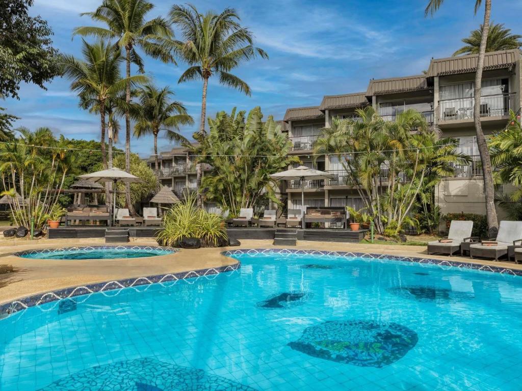 a swimming pool in front of a resort at Mercure Nadi in Nadi