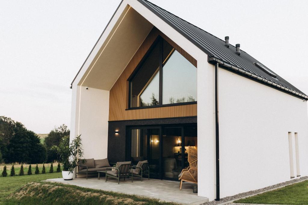 a house with a large window on the side of it at Projekt Babia - Domek z jacuzzi in Lipnica Wielka