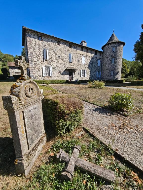 an old cemetery in front of a building at Château de la Moissetie in Aurillac