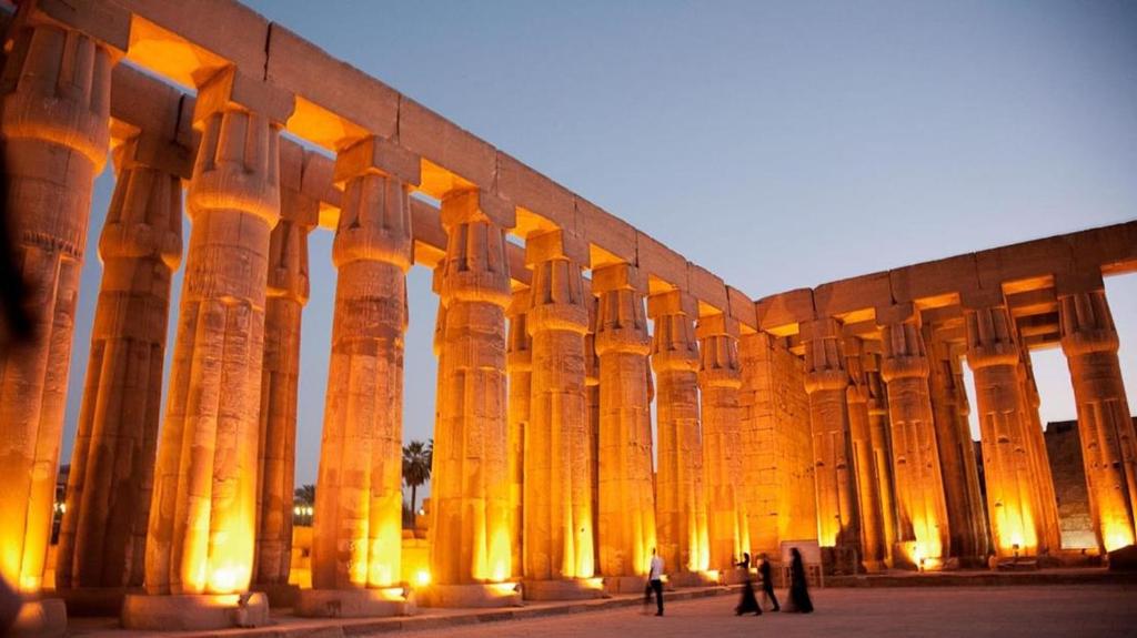 a large building with columns in front of it at International Pyramids Hotel & Roof Top in Cairo